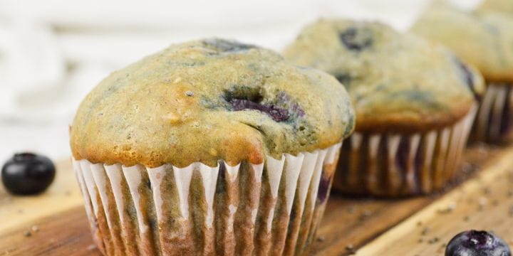 healthy blueberry muffin in a paper on a board