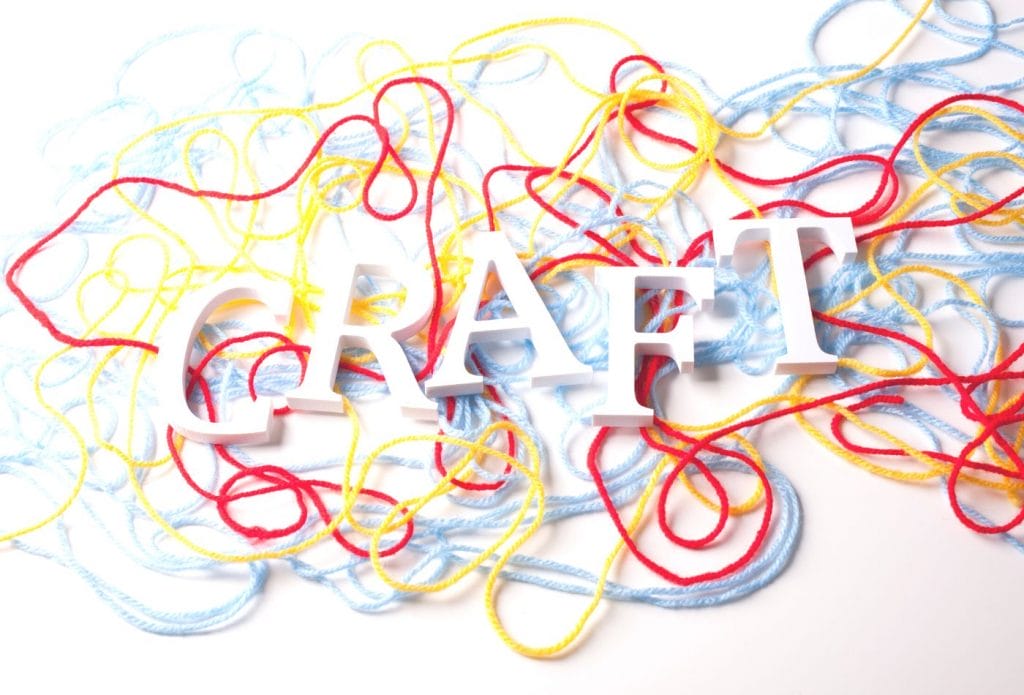 letters spelling craft surrounded with yarn
