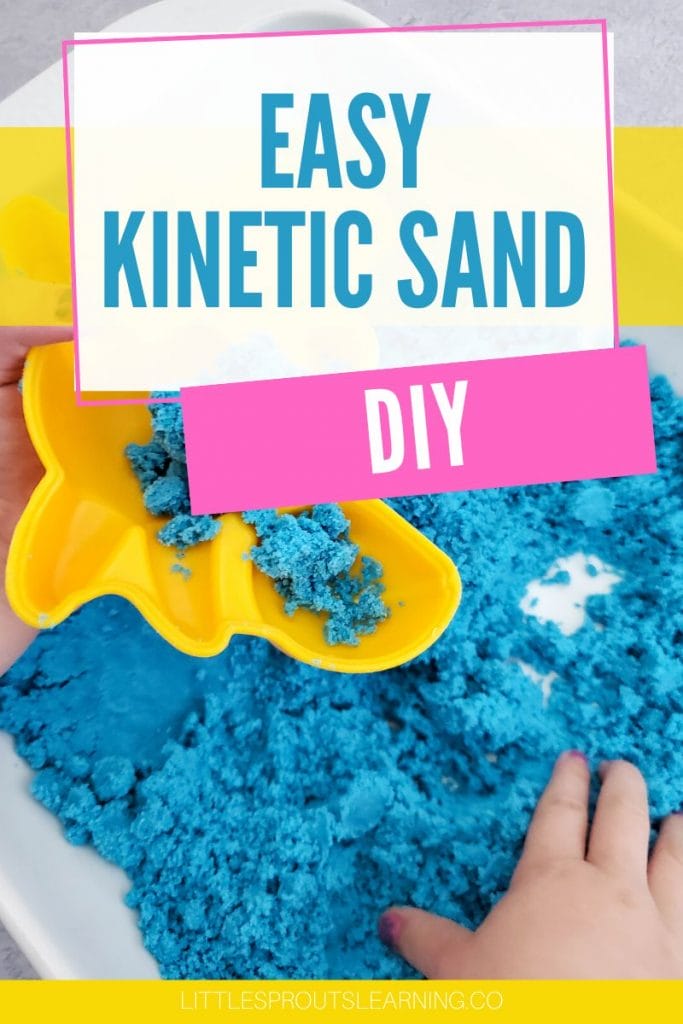 kinetic sand in a sensory table with a mold and little hands