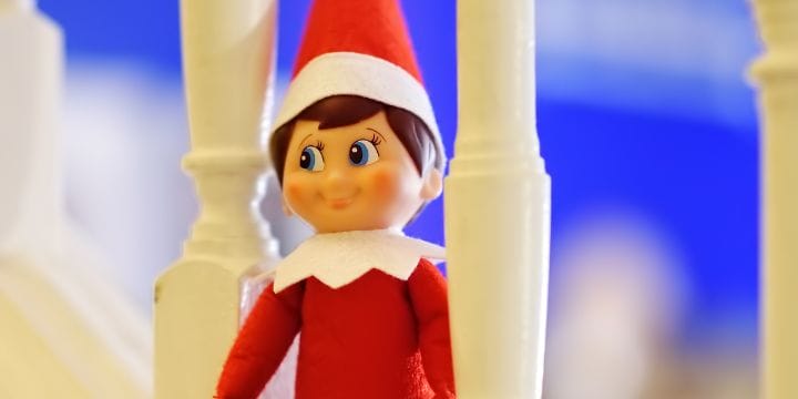elf on the shelf in the stair case railing