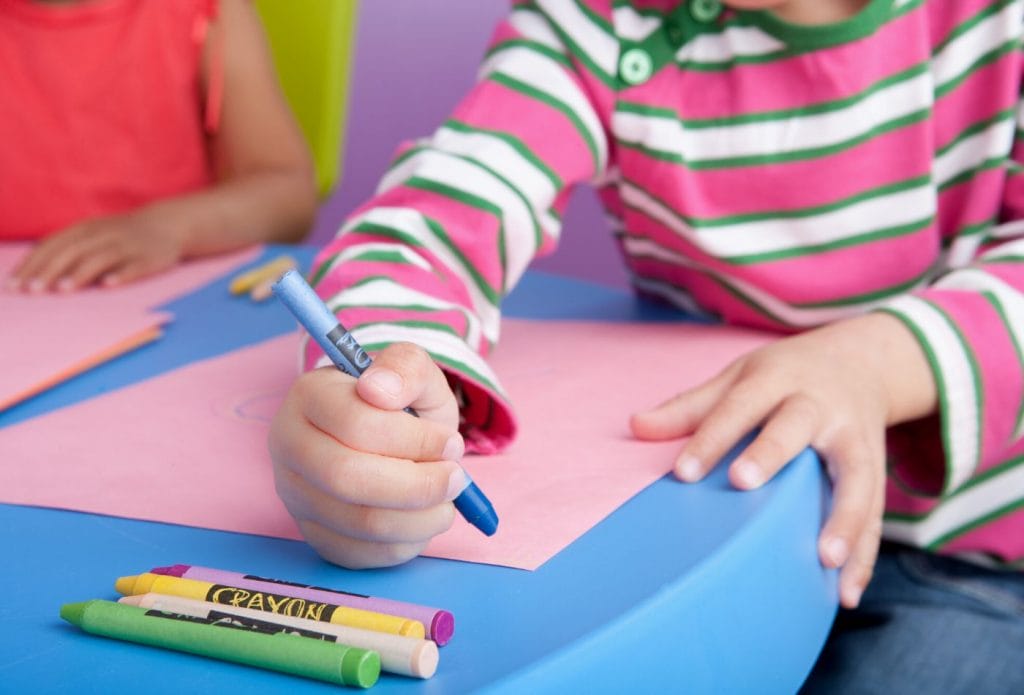 a child coloring on a paper