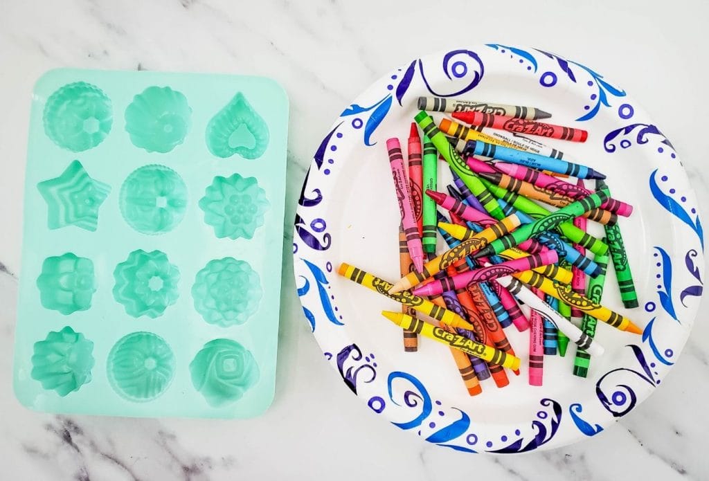 a plate full of crayons and a mold on the counter