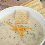 Broccoli cheddar soup in a bowl with a cracker