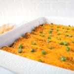 pork enchiladas rolled and baked in a casserole dish