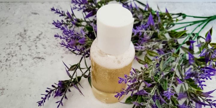 lavender bubble bath in a bottle on the cabinet with some lavender