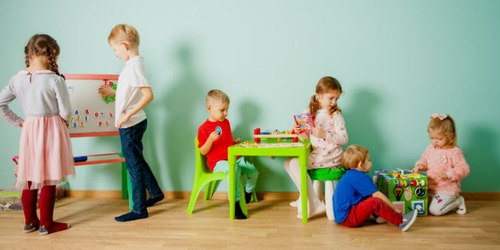 home daycare room arrangement with kids playing