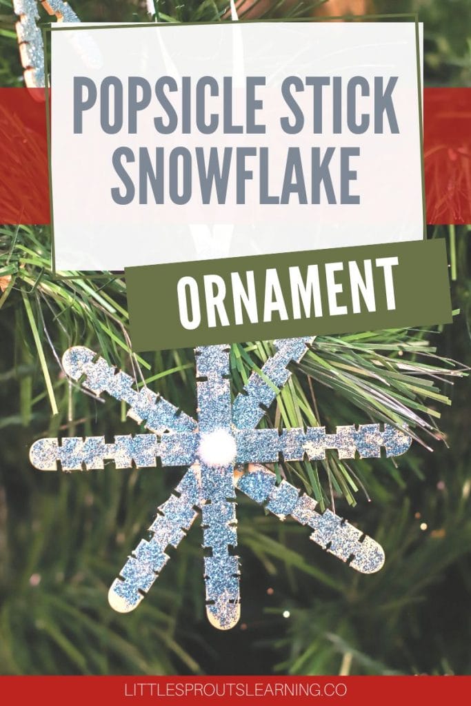 popsicle stick glitter snowflake ornament that kids can make on a tree
