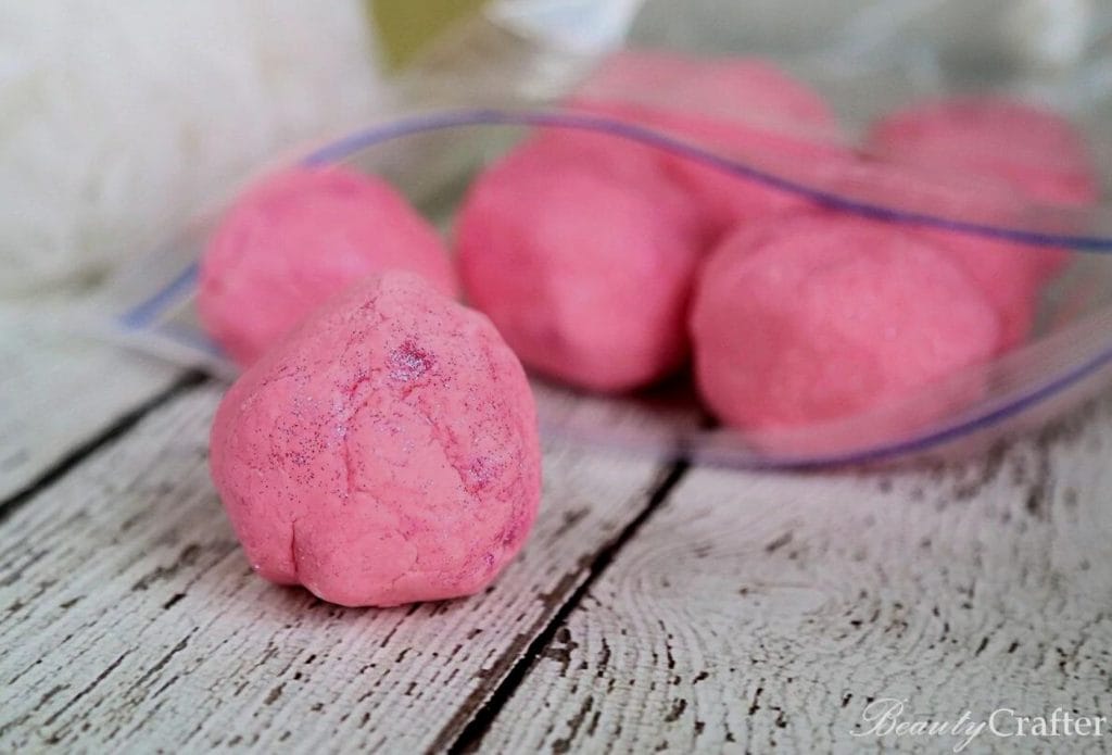 pink glitter homemade playdough in balls on the coutner