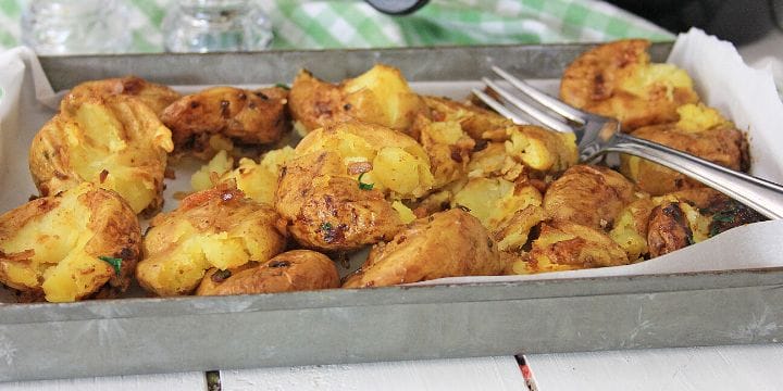 crispy air fried smashed potatoes on a pan with a fork