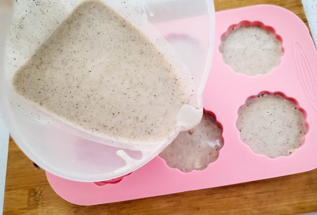 pouring vanilla bean soap base into molds