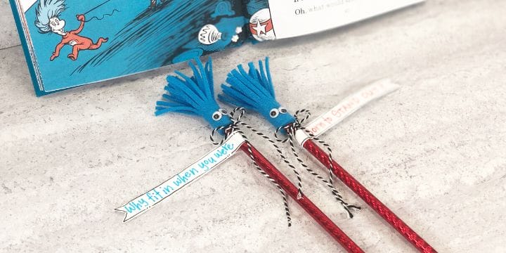 thing one and thing two pencil toppers with tags and bows on a table