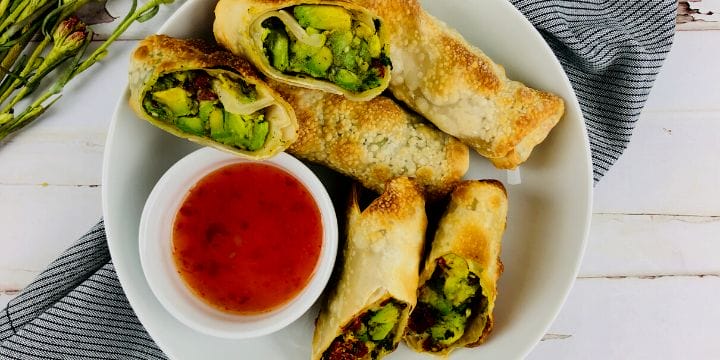 air fryer egg rolls on a plate with dipping sauce