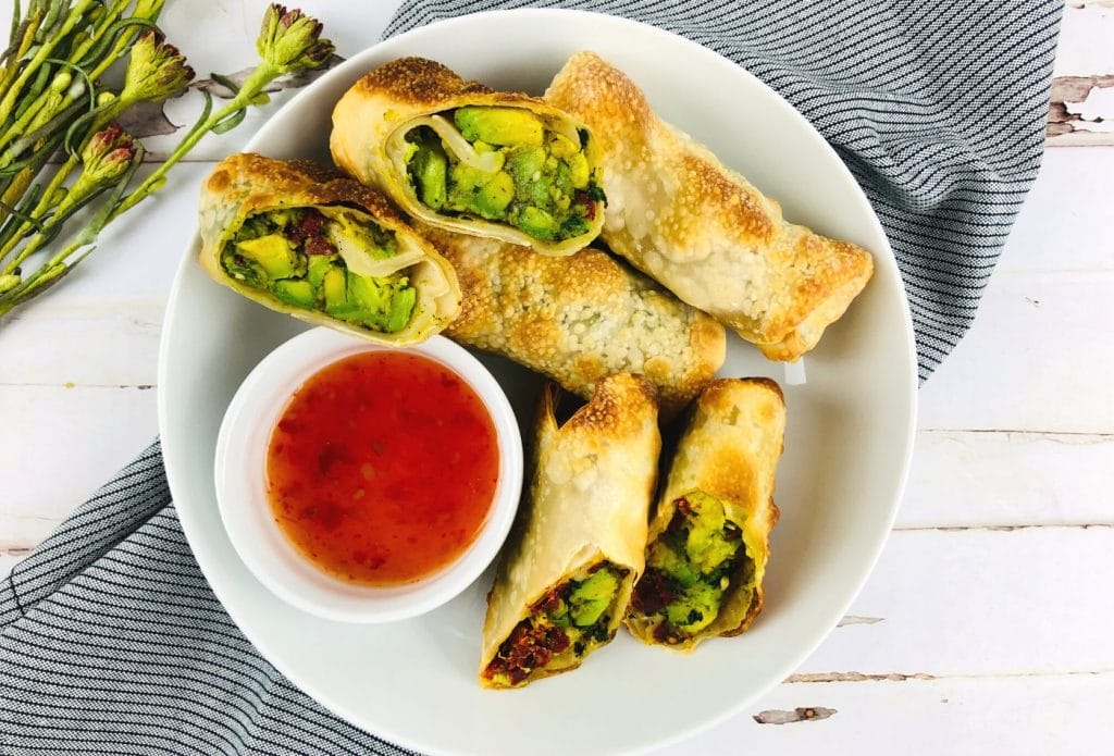 air fried avocado rolls on a plate with sauce