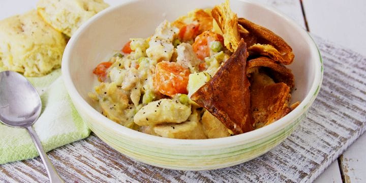 chicken pot pie stew in a bowl on a board