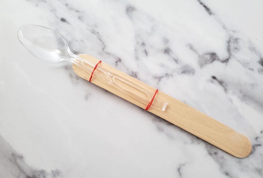 popsicle sticks banded together with a spoon