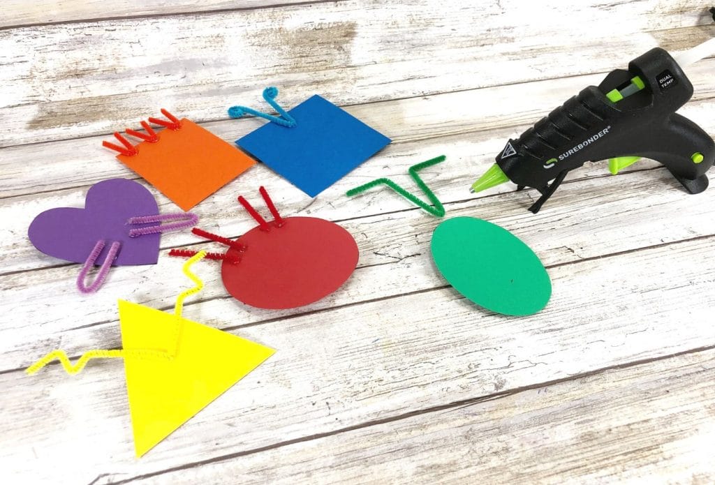 Hot gluing pipe cleaners on shapes