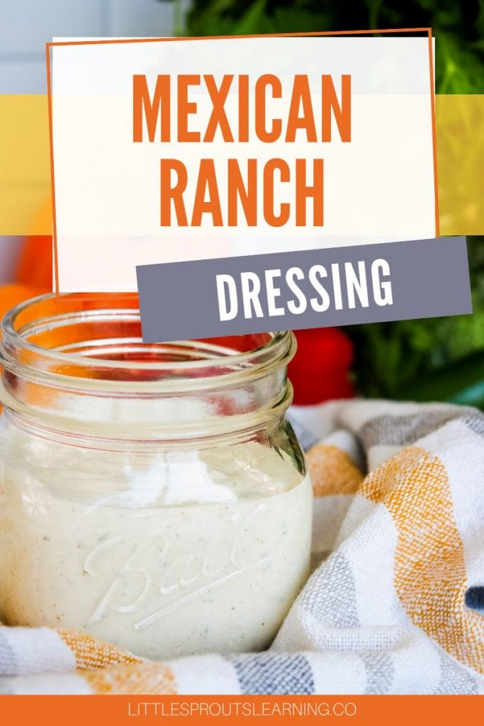 Mexican ranch dressing in a jar on a towel next to some vegetables