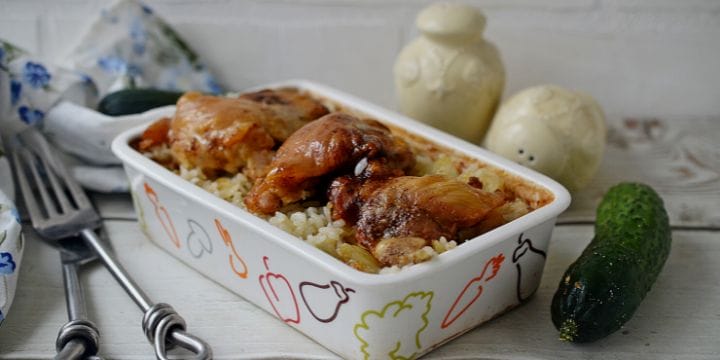 oven chicken and rice on the counter with silverware and salt and pepper shakers