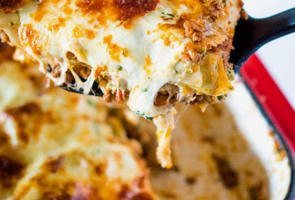 slice of lasagna over a pan