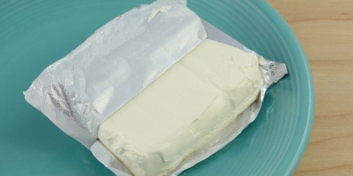 block of cream cheese on a blue plate