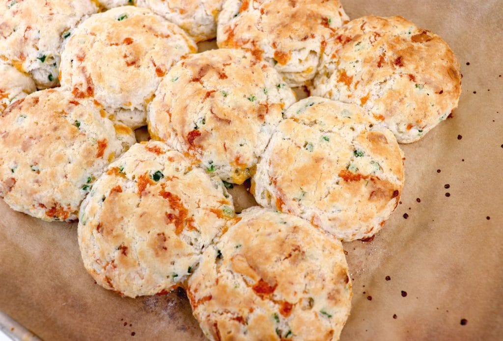 cheddar biscuits fresh from the oven on parchment