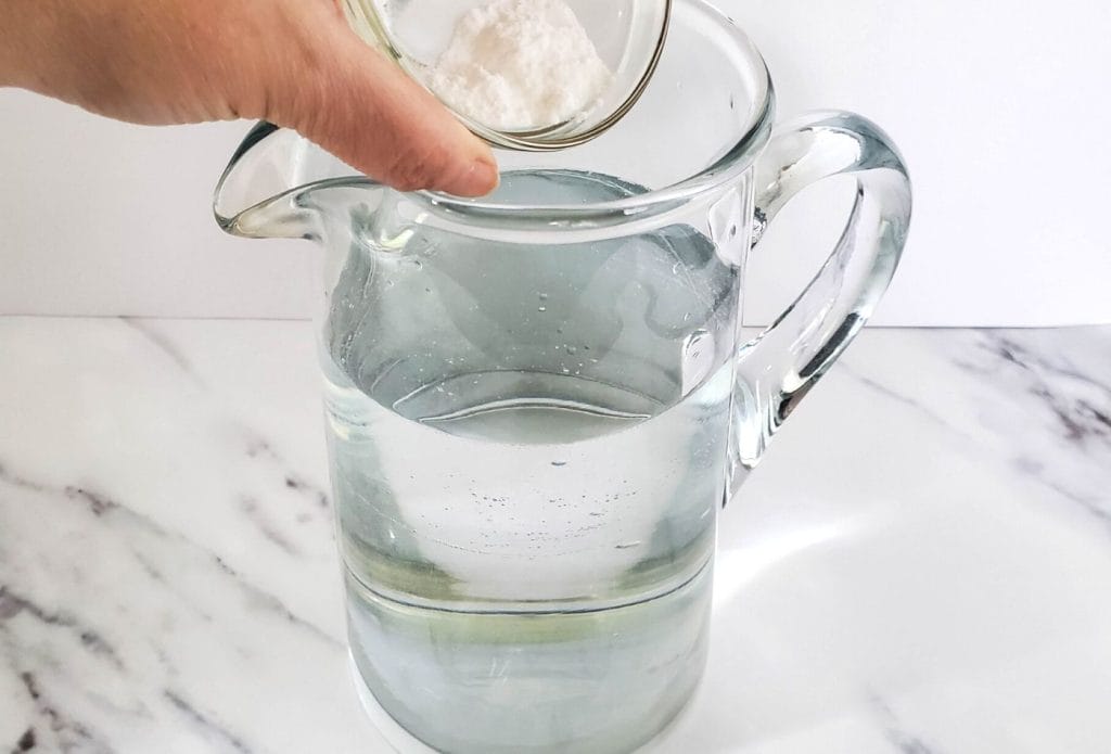 ingredients for homemade plant food going into a pitcher