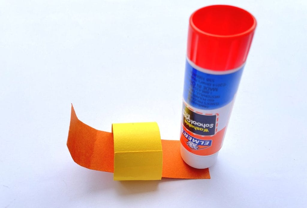 glue stick gluing a paper chain together