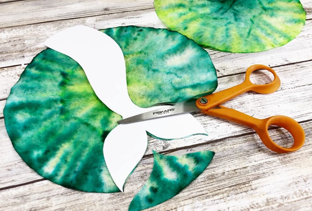 mermaid tail pattern on a colored coffee filter and some scissors