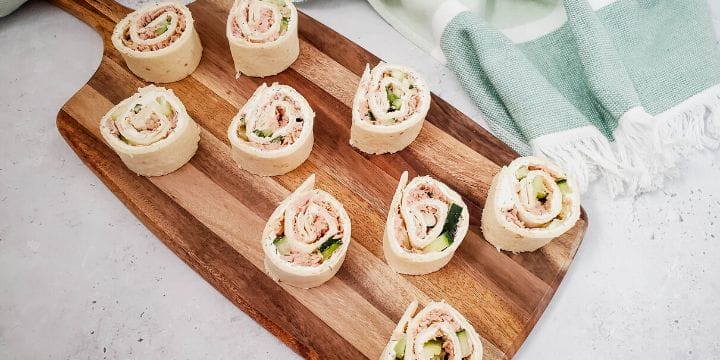 cucumber tuna roll ups on a board