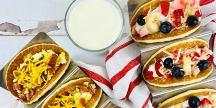 sweet and savory pancake tacos on a board with milk and a red striped towel