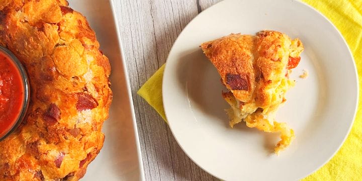 pepperoni pull apart bread on a plate with a slice on a plate