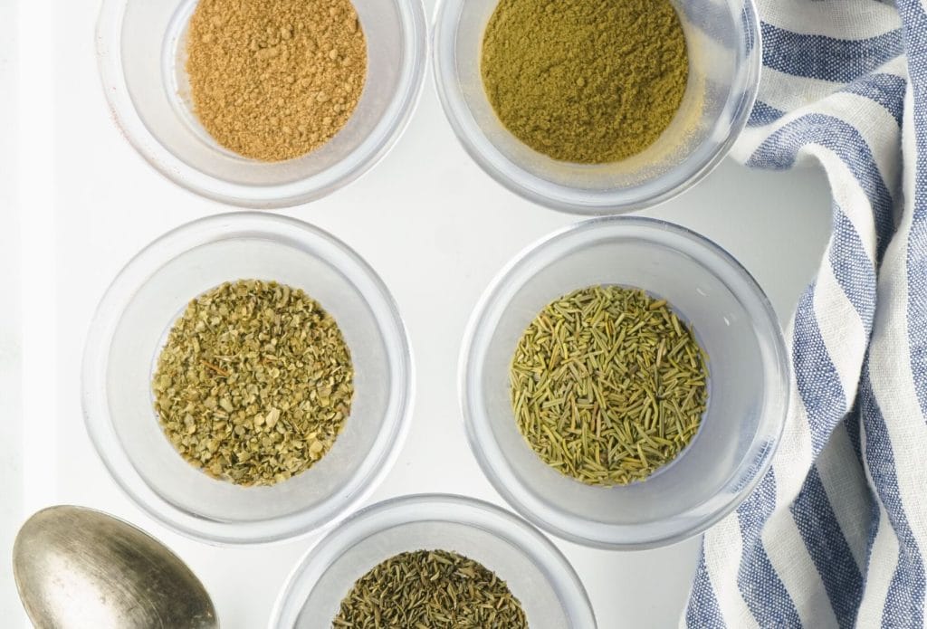 spices for poultry seasoning mix in bowls