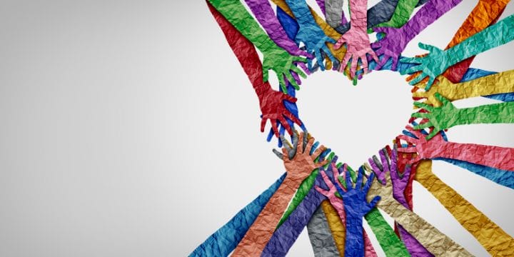 different colored hand cut outs in the shape of a heart.