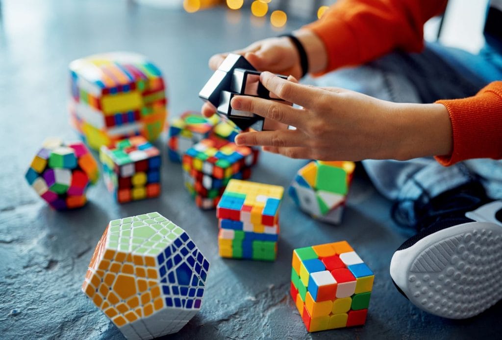 a child's hands playing with different puzzle games