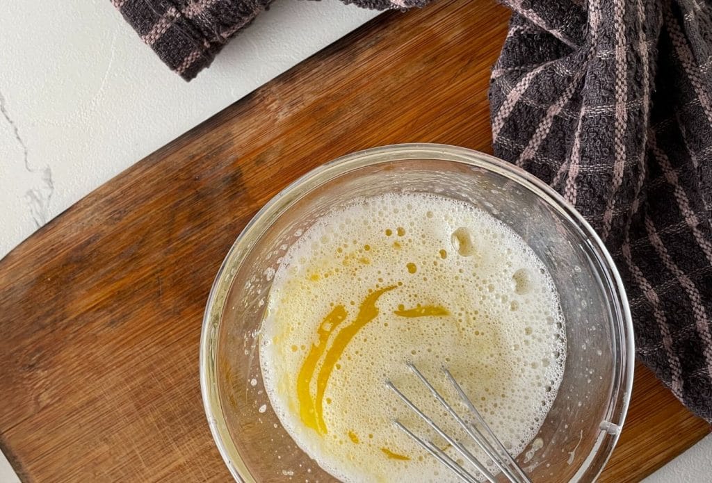 lemon curd mixed well in a bowl with a whisk