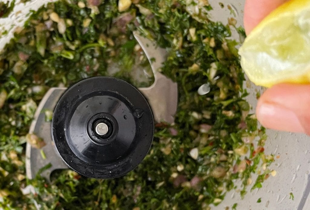 ingredients for chimichurri being blended in a food processor