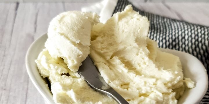 homemade cream cheese in a bowl with a knife