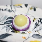 homemade vanilla chapstick in a pot on a towel