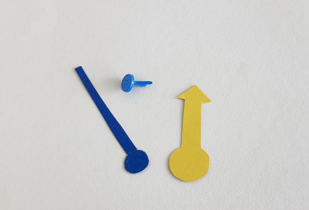 the hands for a paper clock and a blue brad