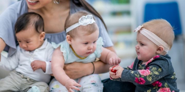 daycare provider holding a baby