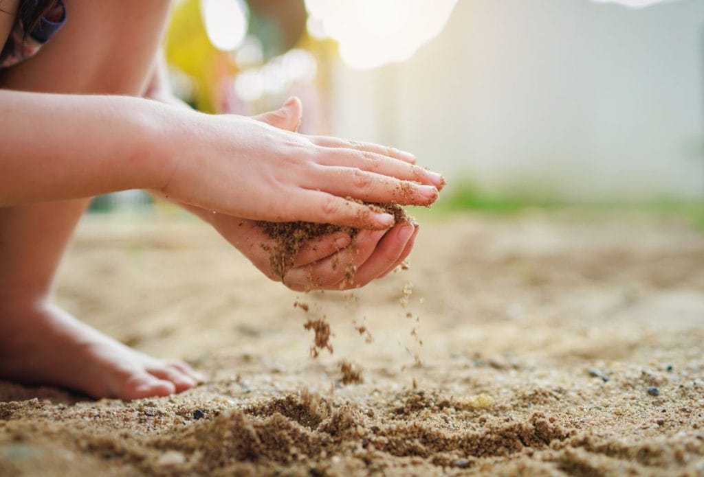 a child playing in the sand