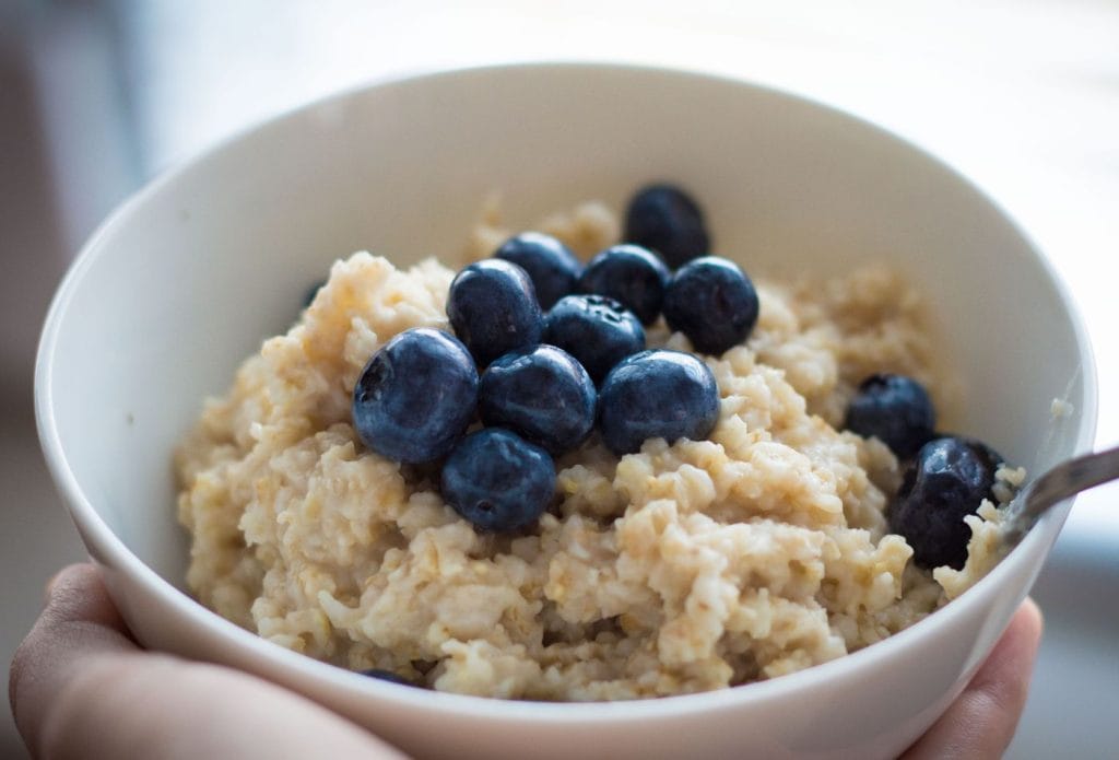 bowl of oatmeal with blueberries on top