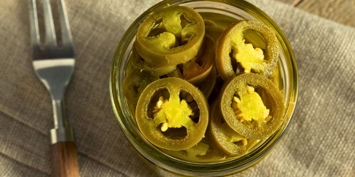 top view of a jar of pickled jalapeno pepper slices