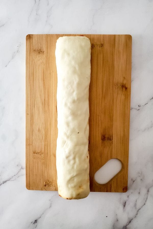 log of pizza rolls ready to be cut