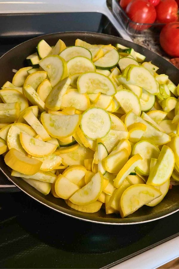 cut up zucchini and yellow squash in a skillet