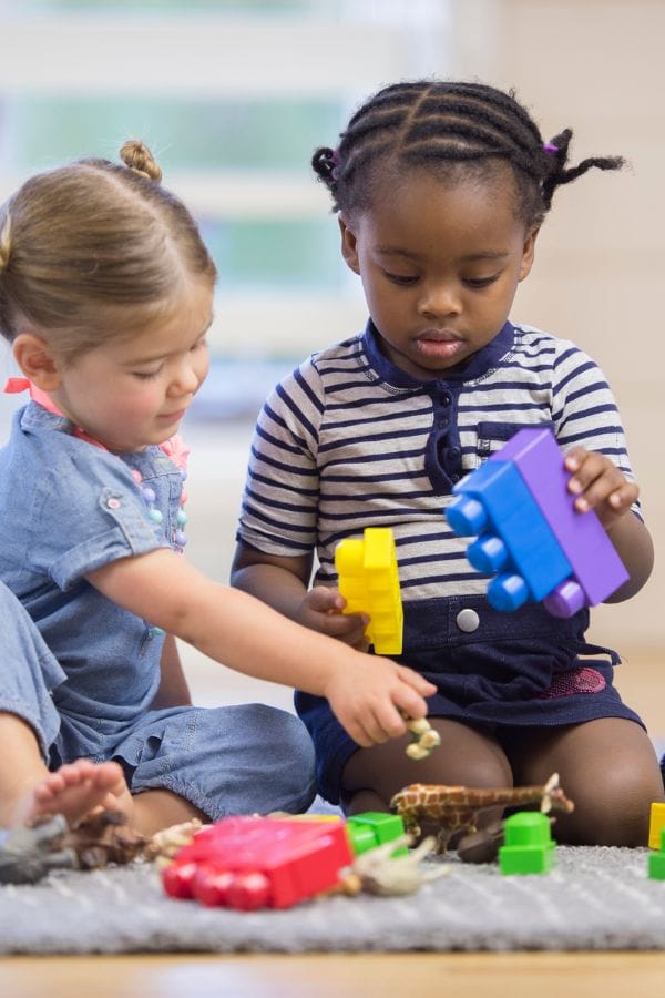 toddlers sharing toys at daycare
