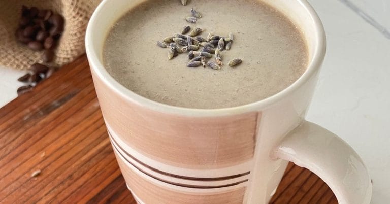 honey lavender latte in a pink cup on a board