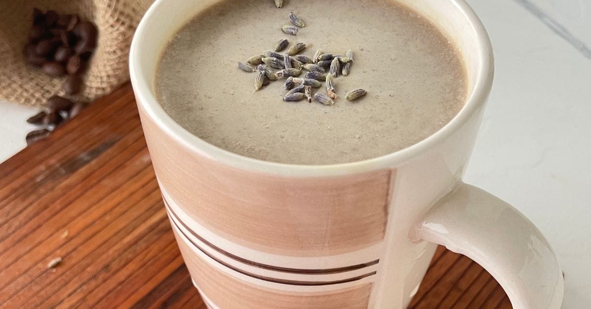 honey lavender latte in a pink cup on a board