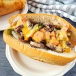cheese dip philly cheesesteak sandwich on a plate