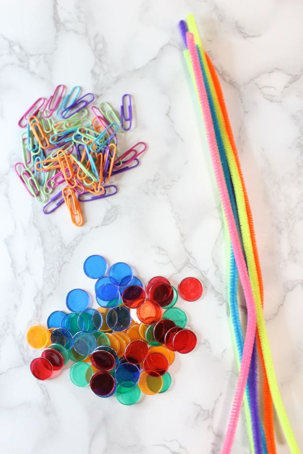 magnets, paper clips, and pipe cleaners on a board